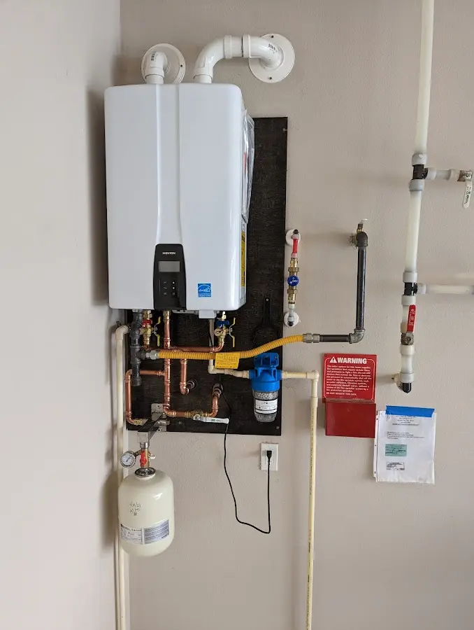 Professional plumber installing copper piping in a Endicott home